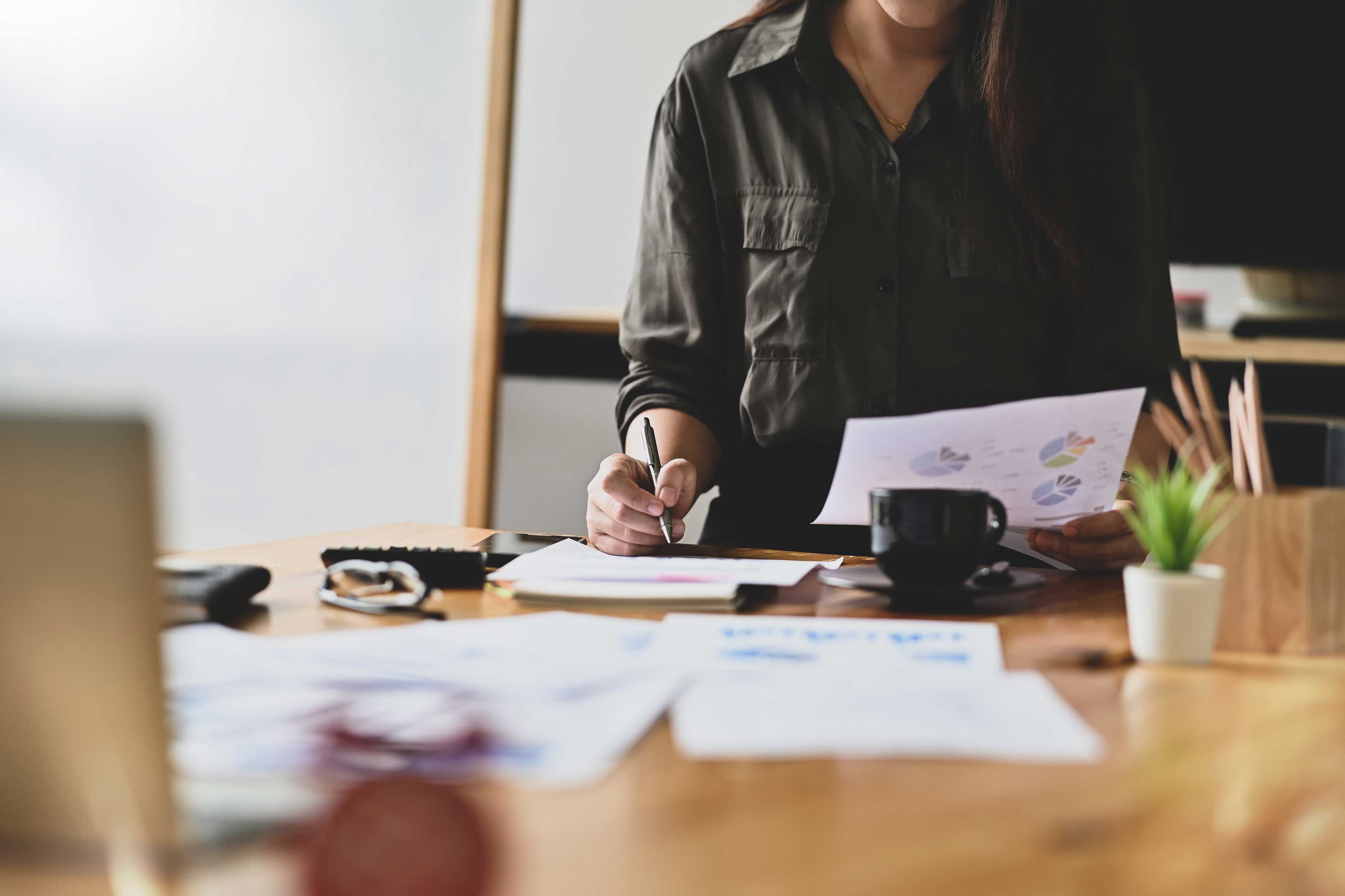 ey-woman-sitting-holding-paper