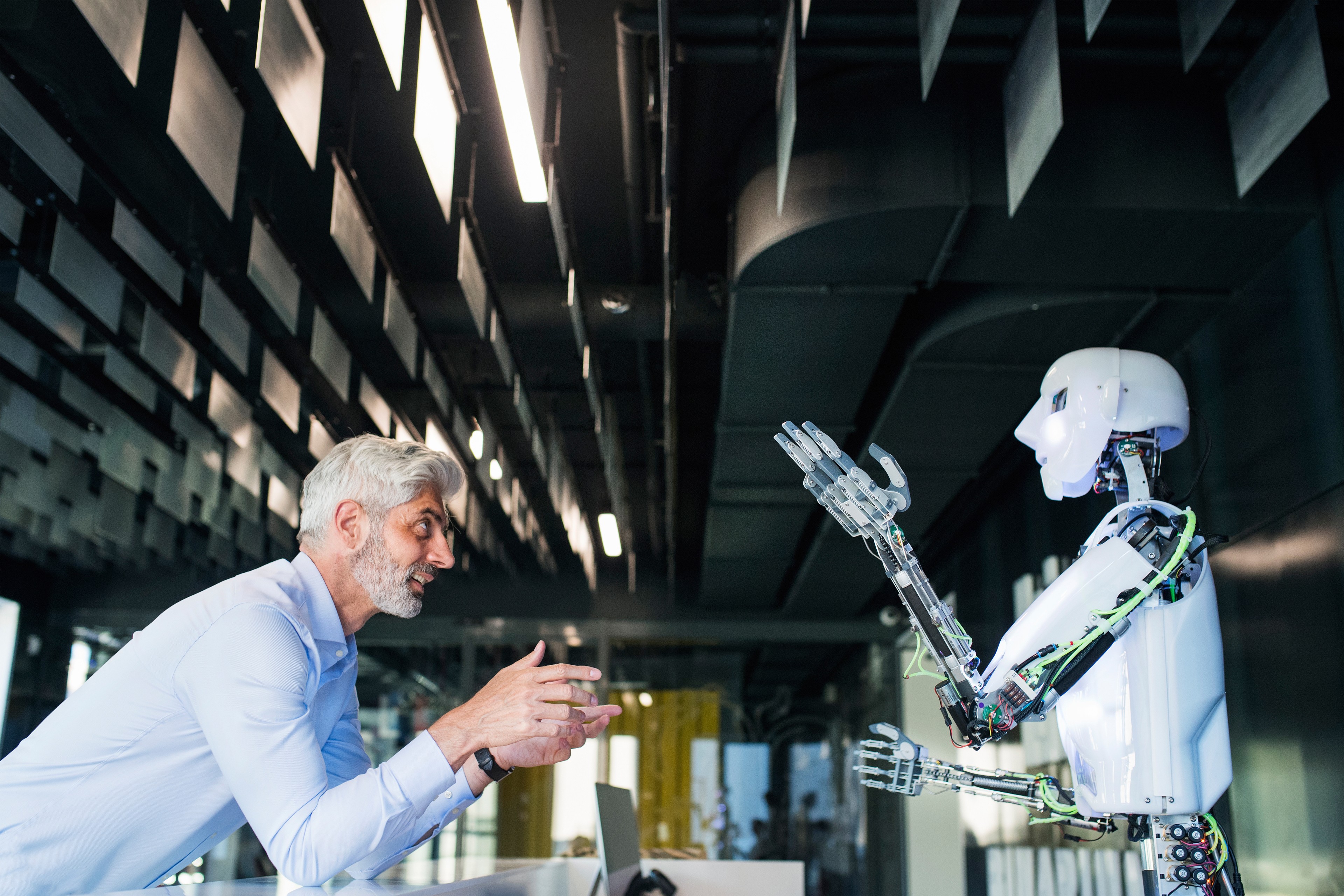 Man looking at a robot