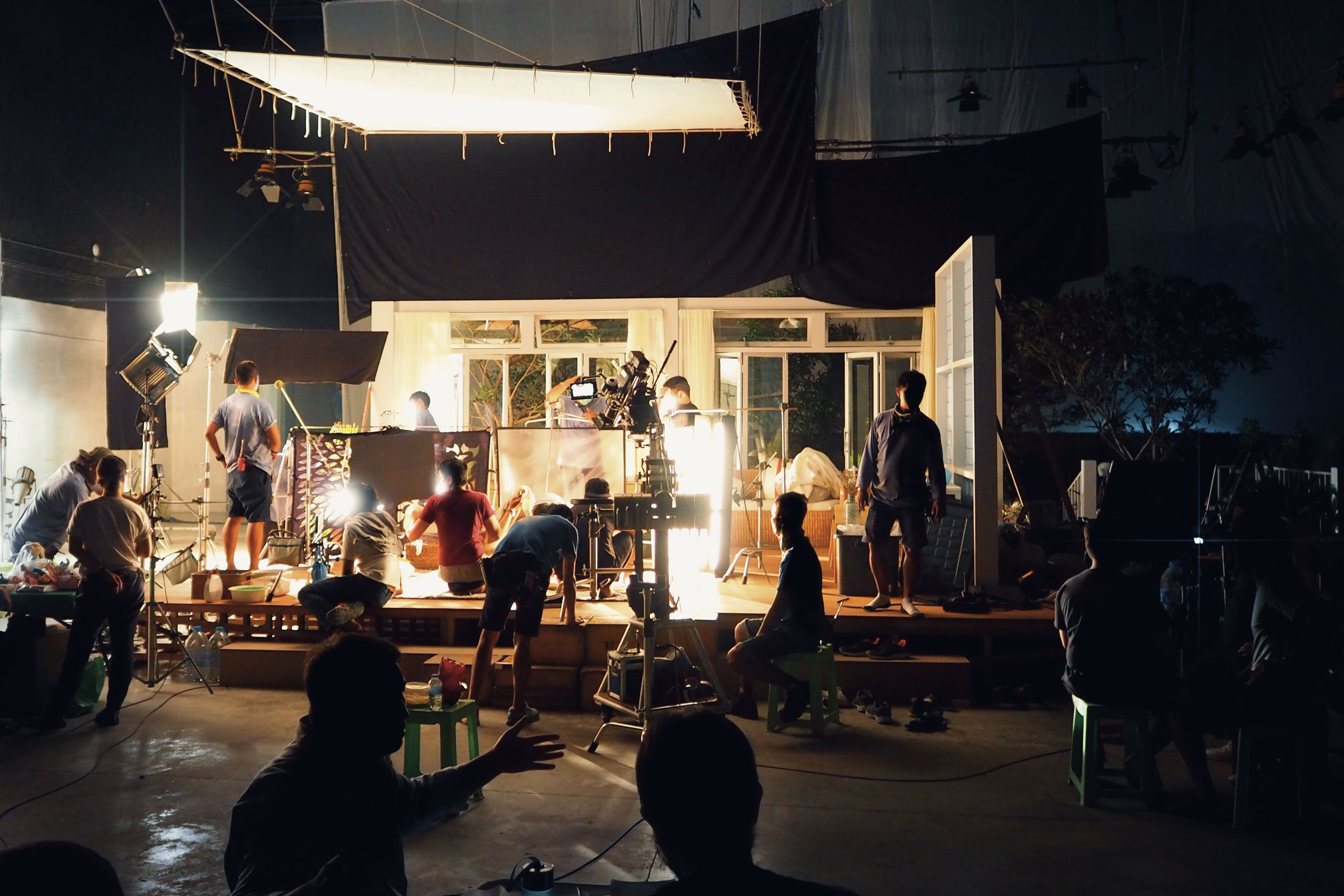 Silhouette of people working in big production studio for shooting