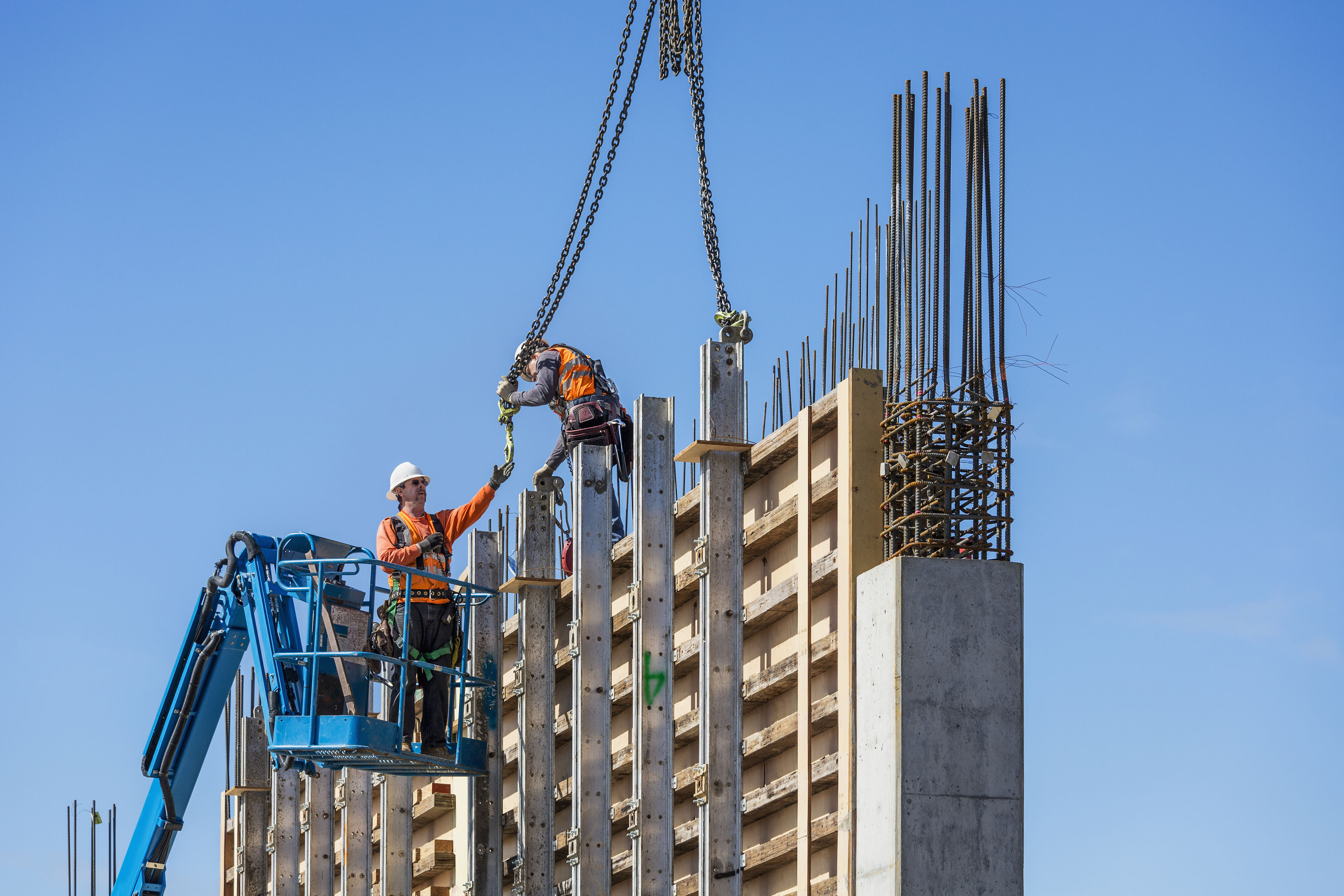 EY workers concrete wall construction site