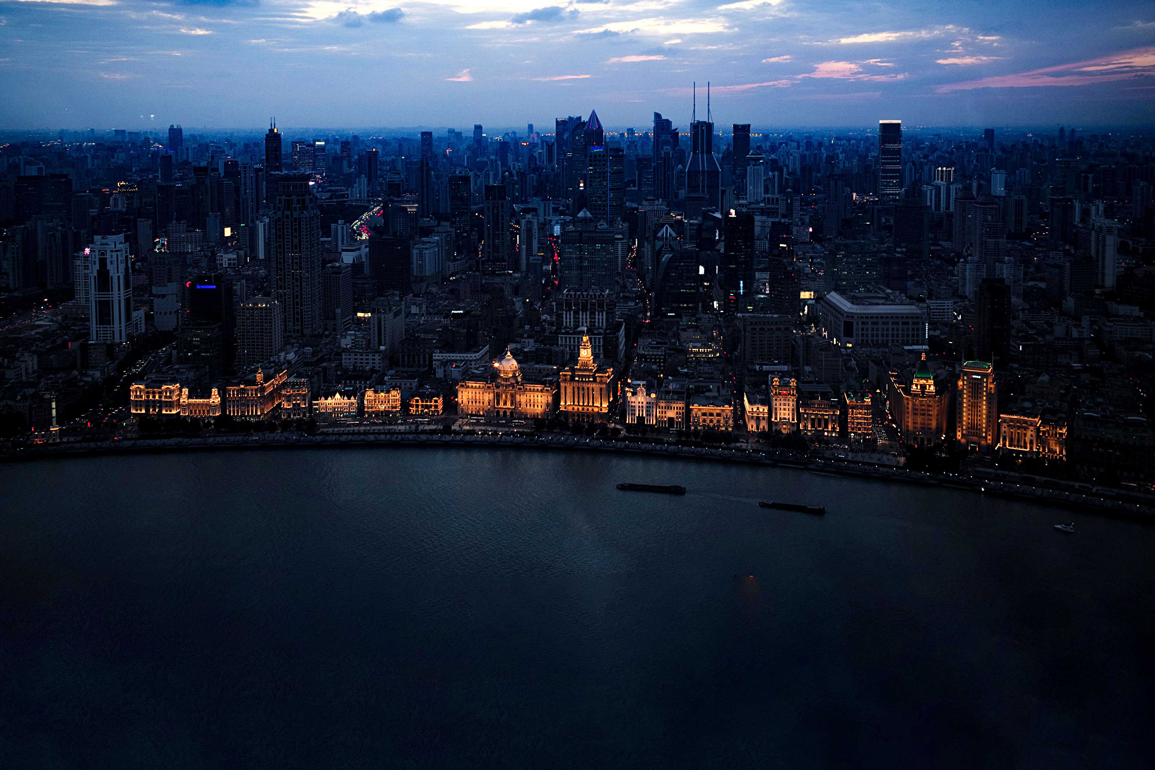 City at night with illuminated waterline buildings