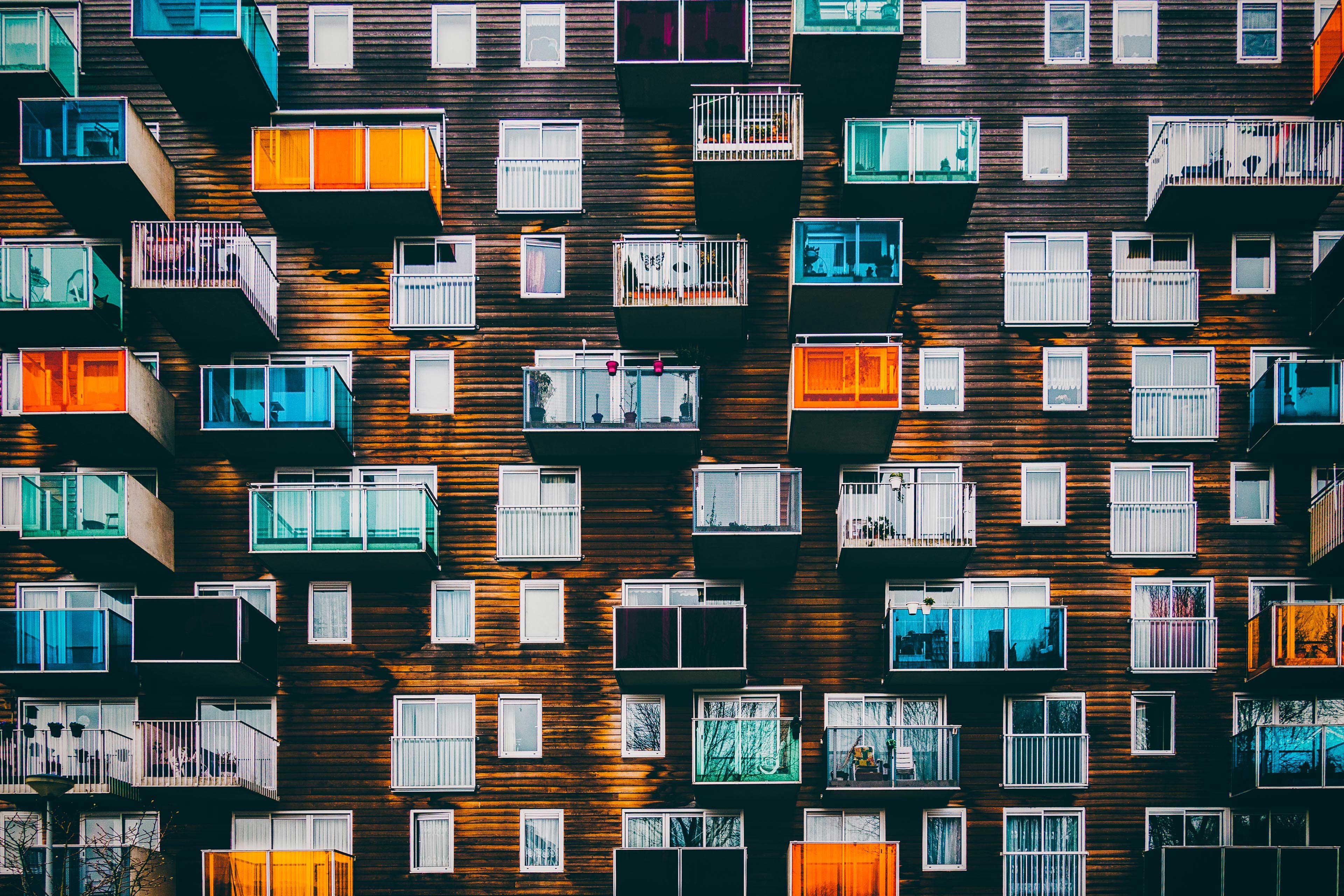 EY facade of building with many different colored balconies