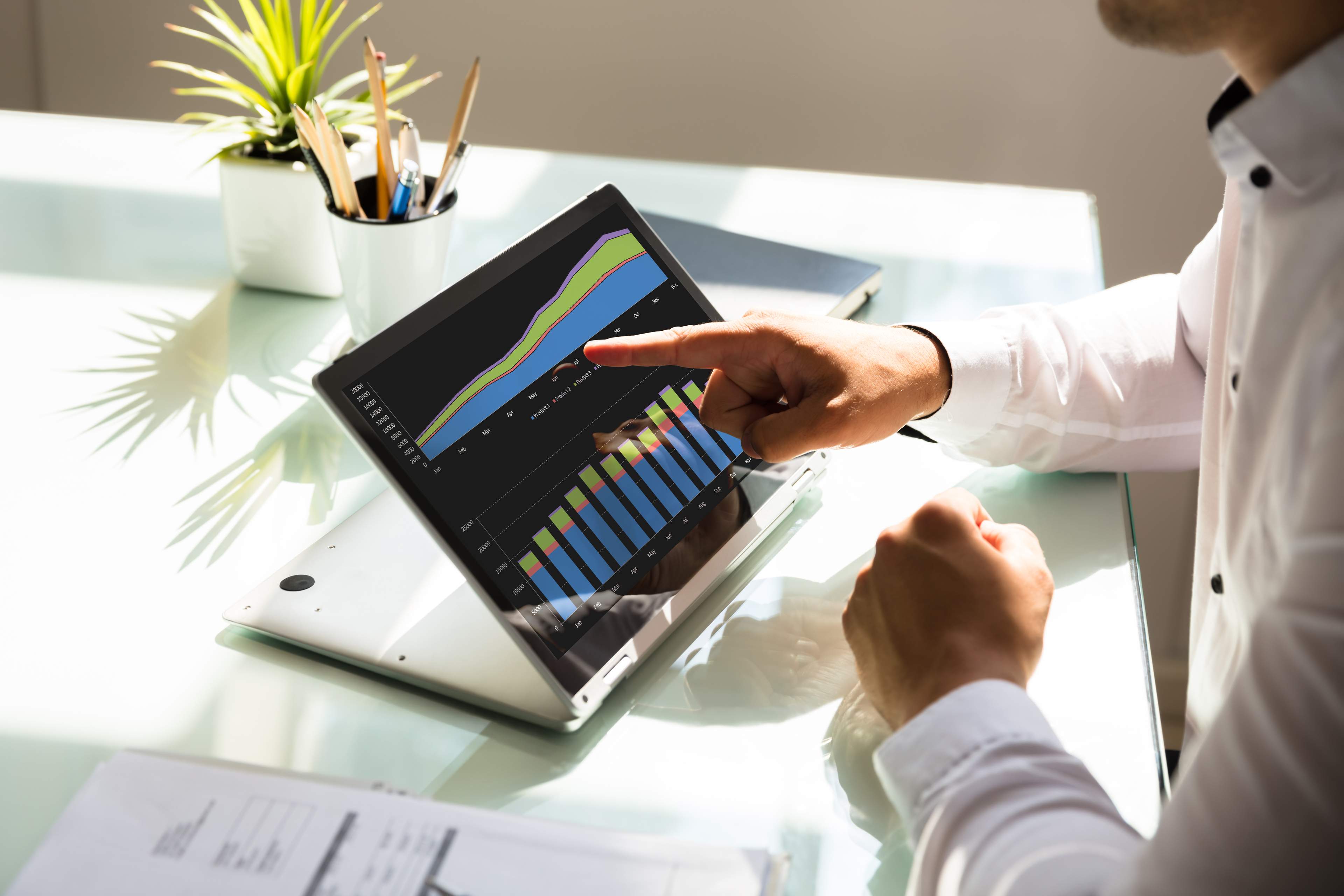 Businessman analyzing graph on laptop