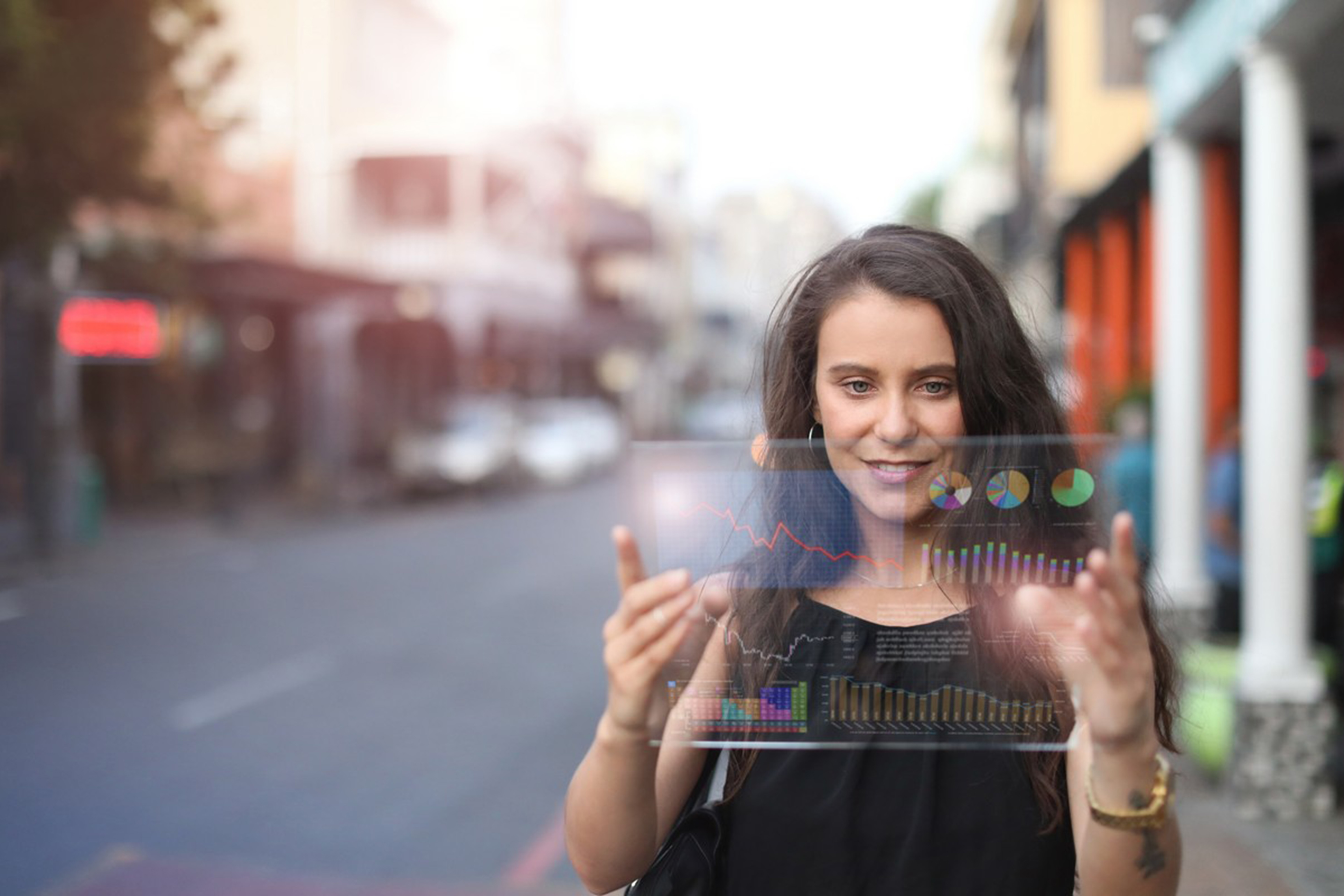 Woman holding futuristic tablet