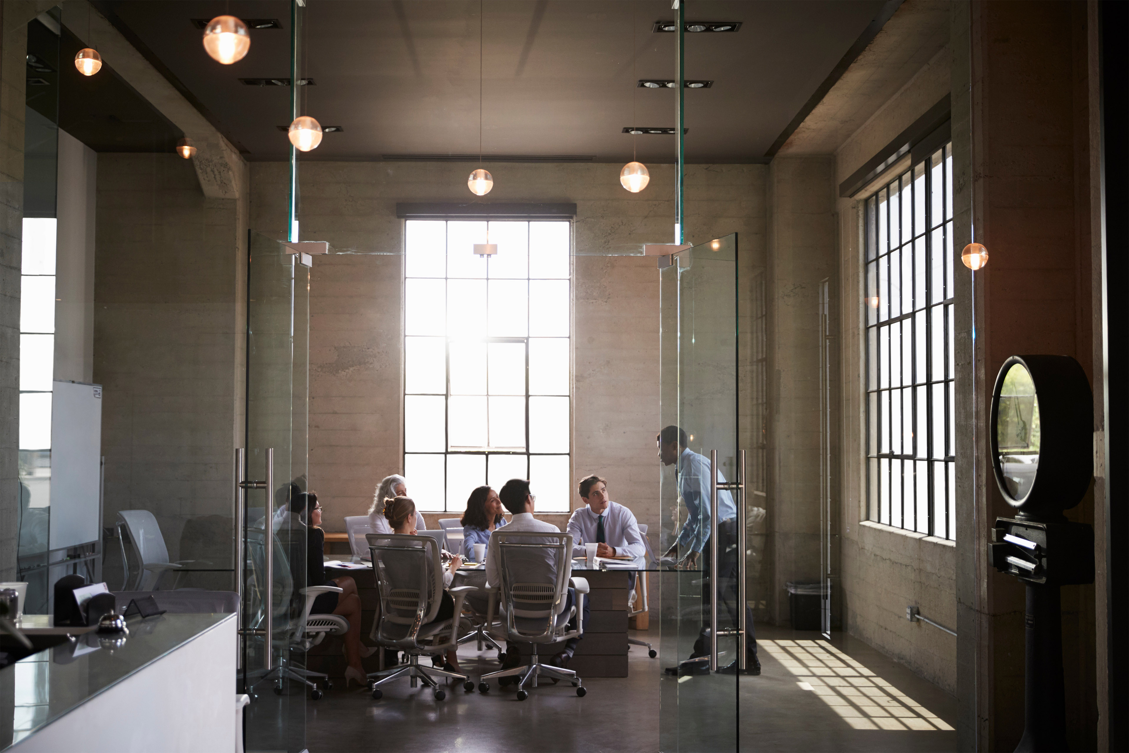 Business colleagues at a meeting in a glass walled boardroom