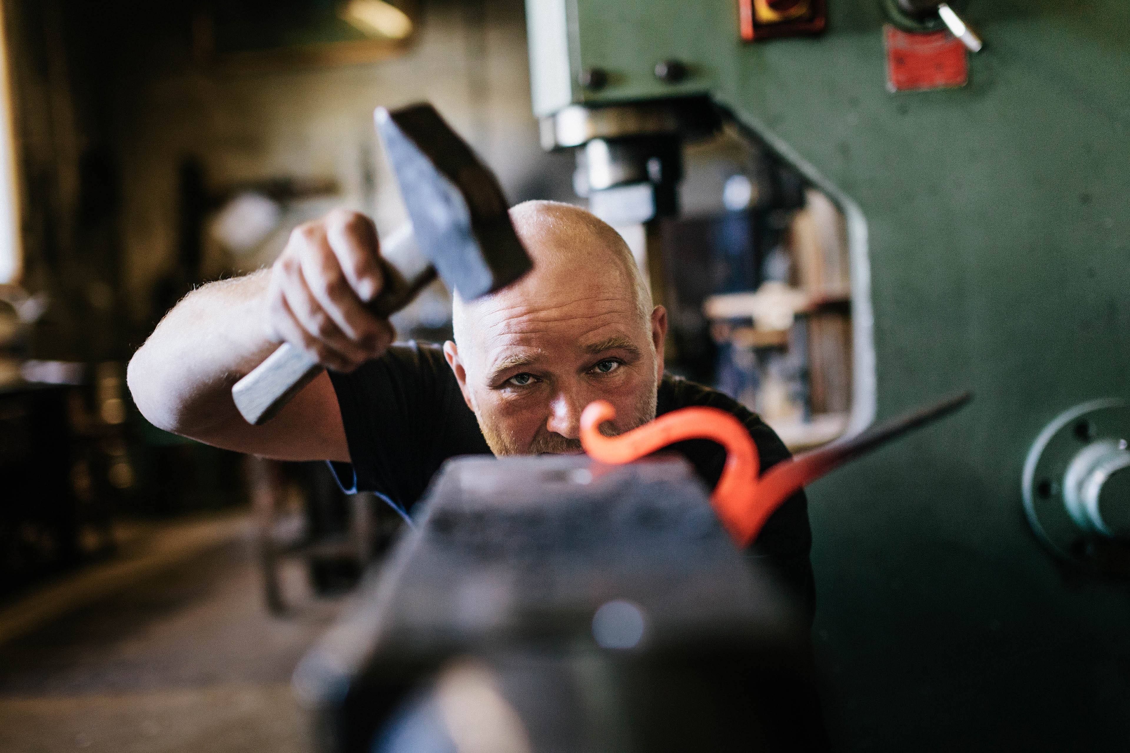 Man bending heated iron object