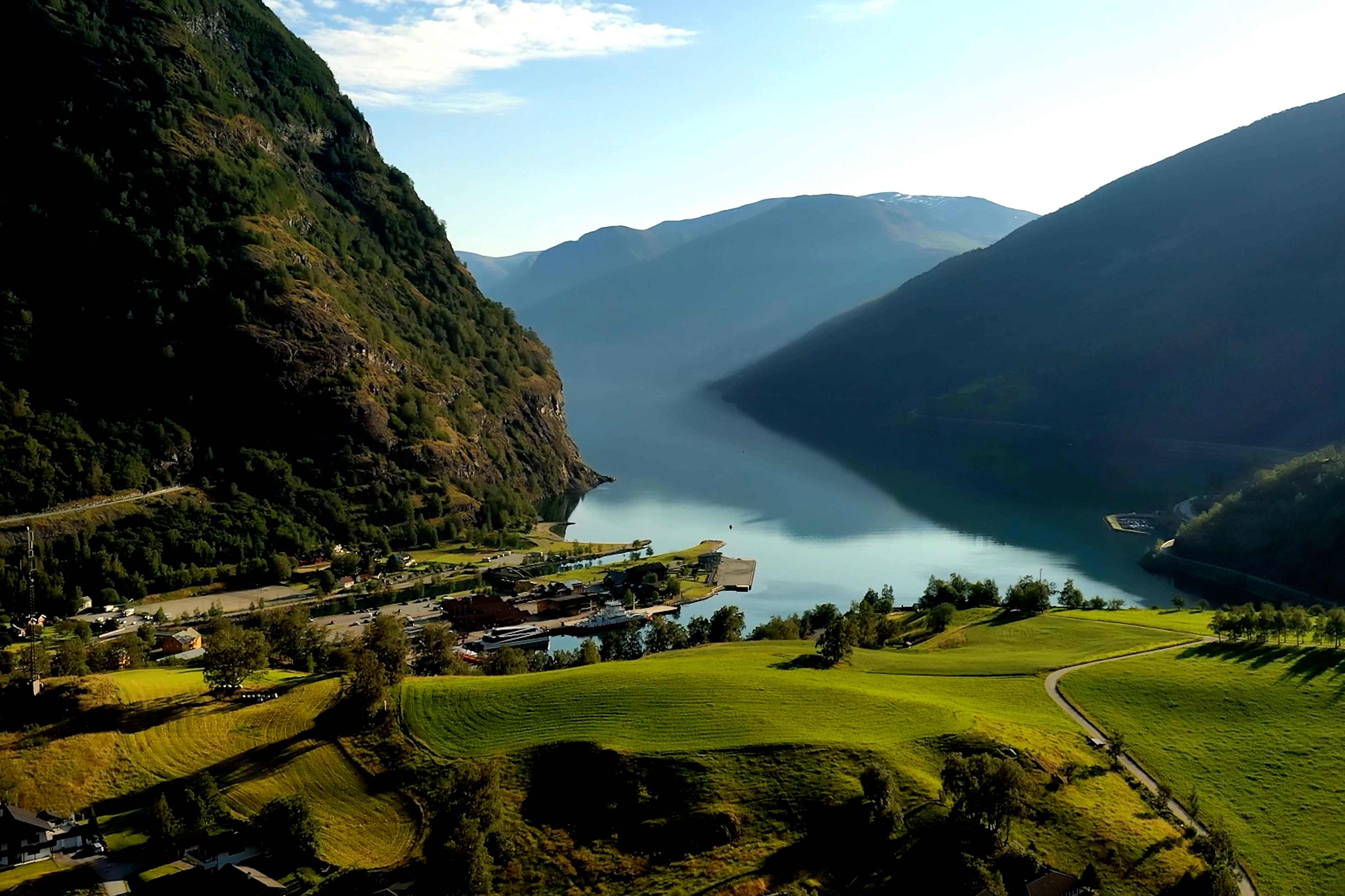 Shot of a hill in a Norwegian fjord with a lake in the background