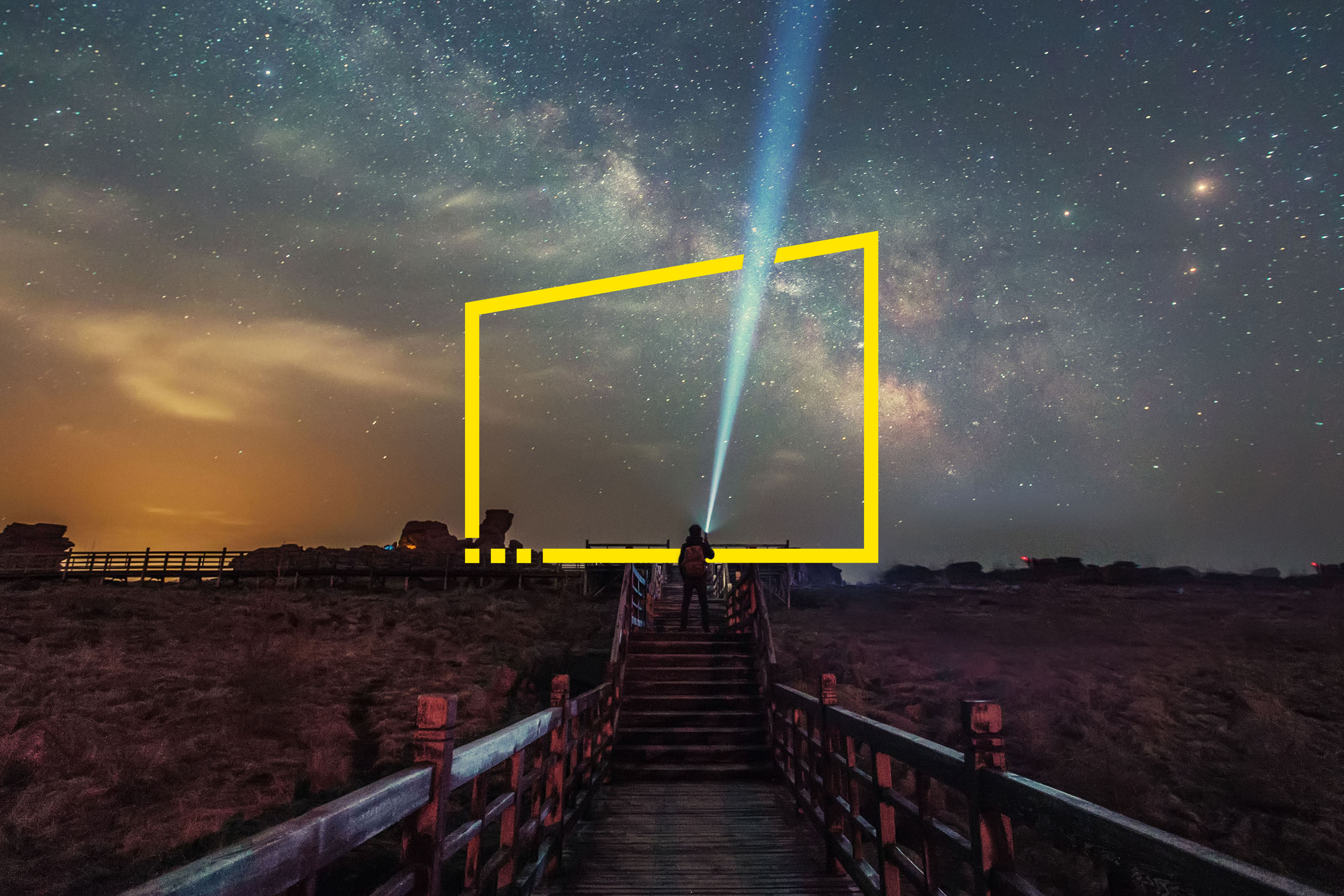 ey-man-shining-flashlight-at-sky-on-boardwalk-in-desert-hebei-china-static