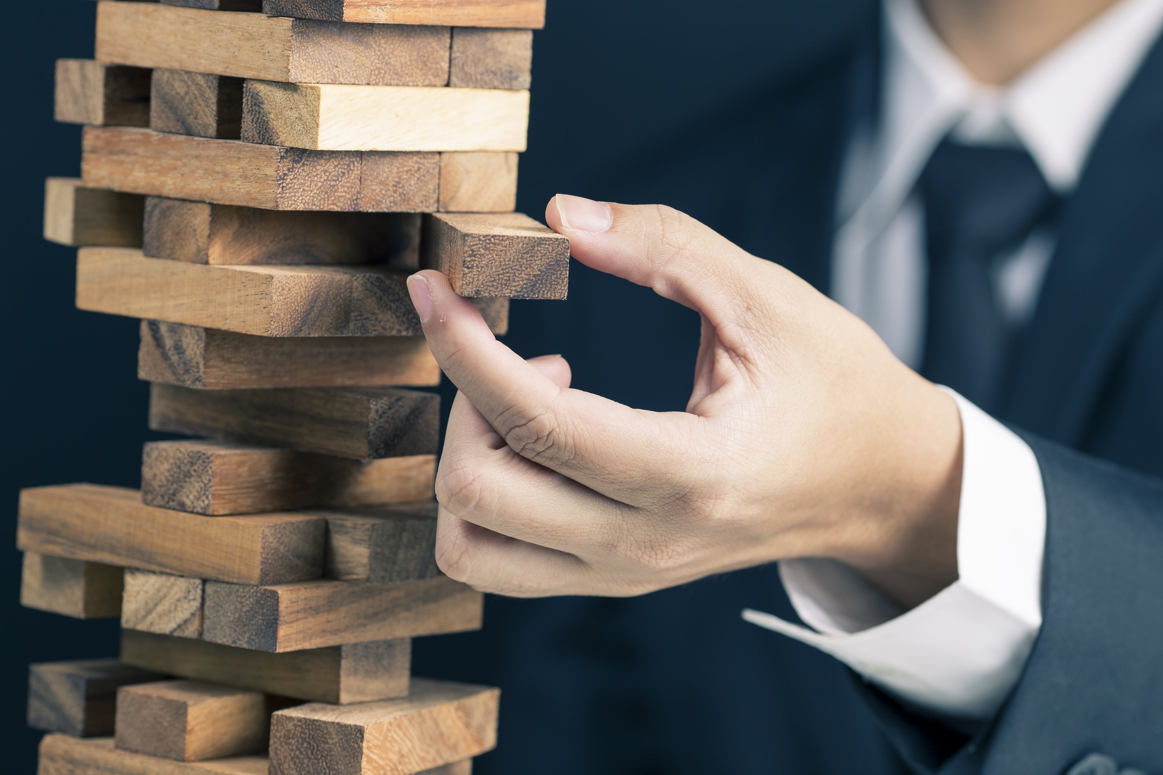 A man removing block from the block game pattern