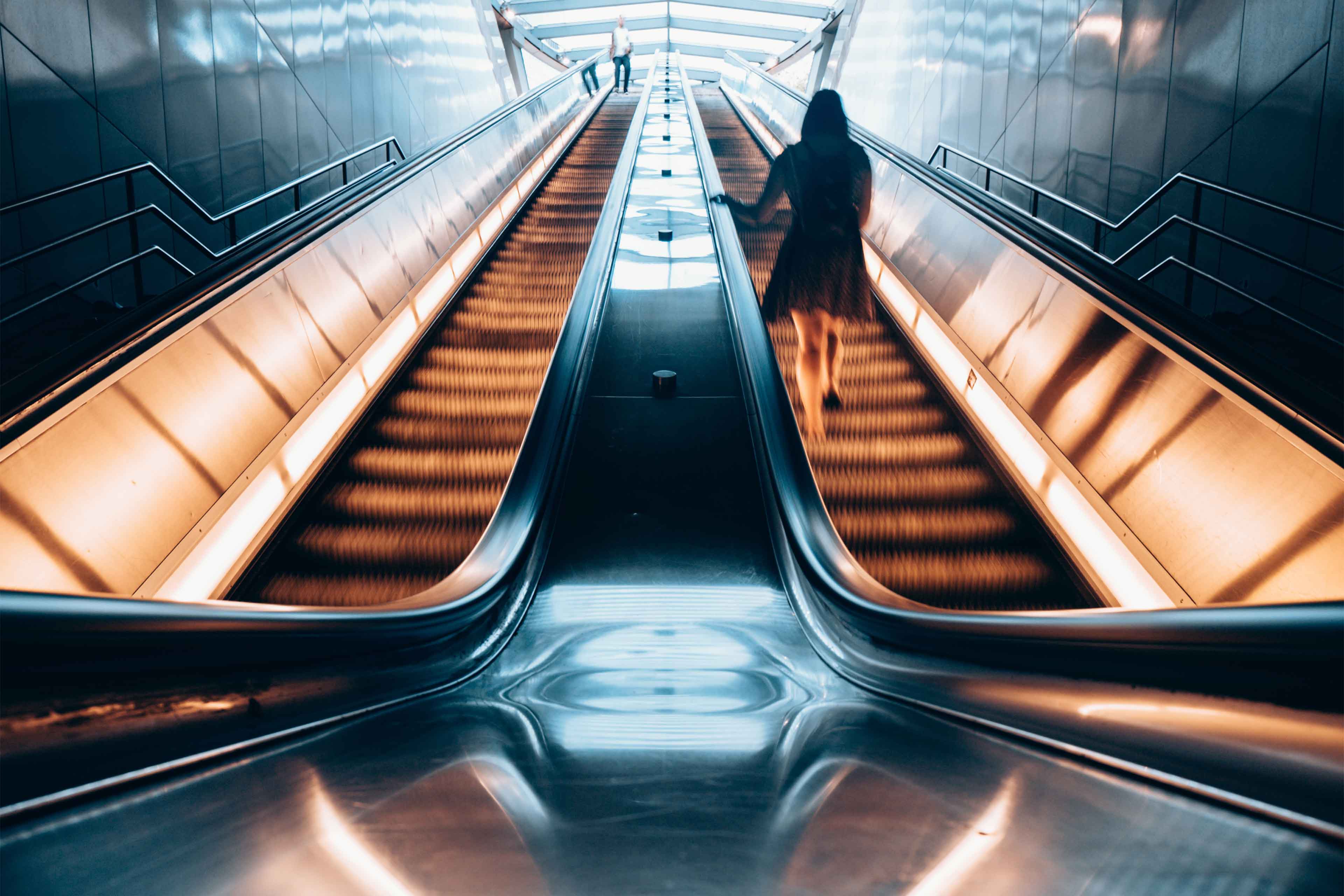 Women walking on the escalator.