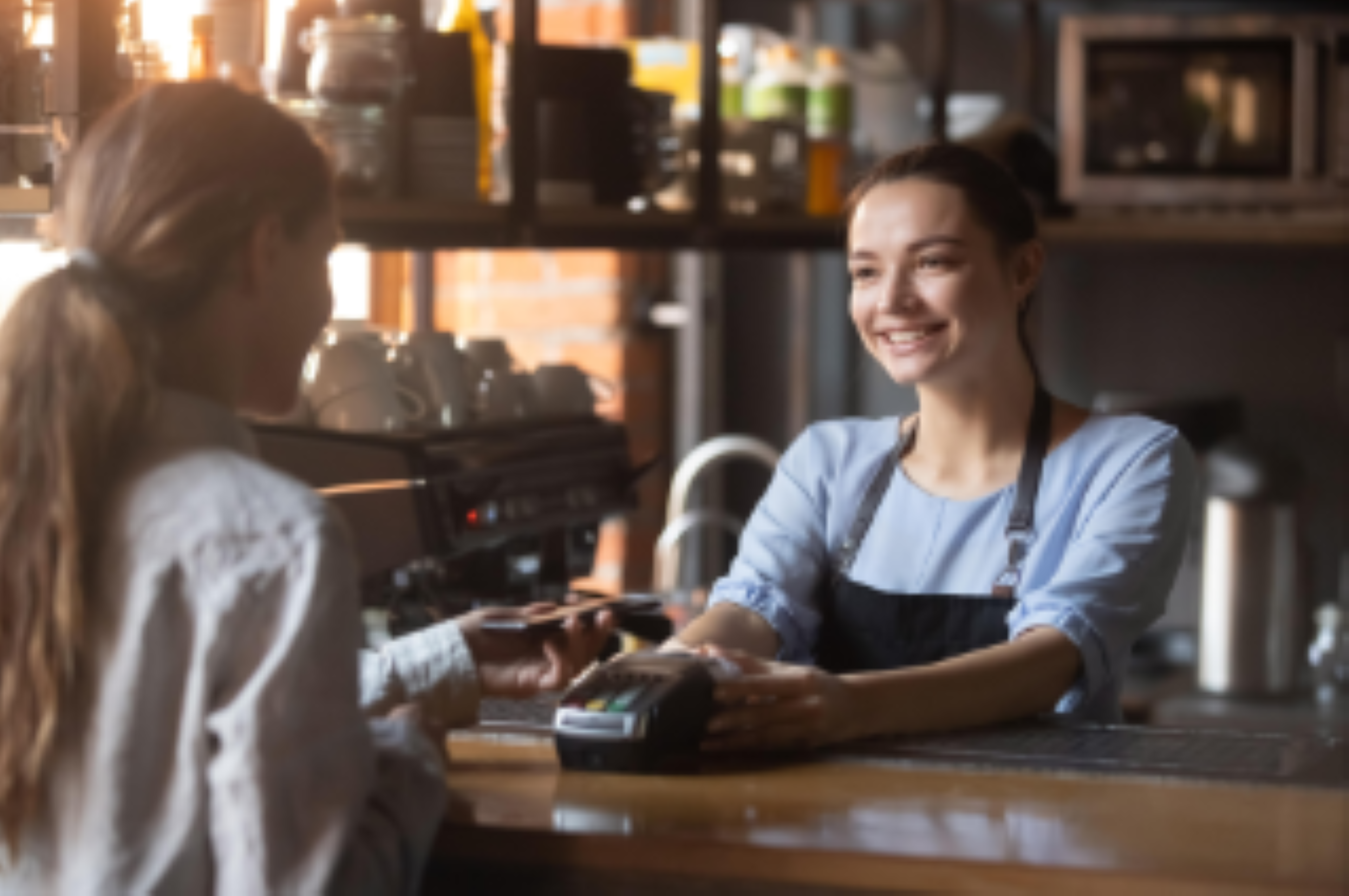 Customer making payment at coffee shop