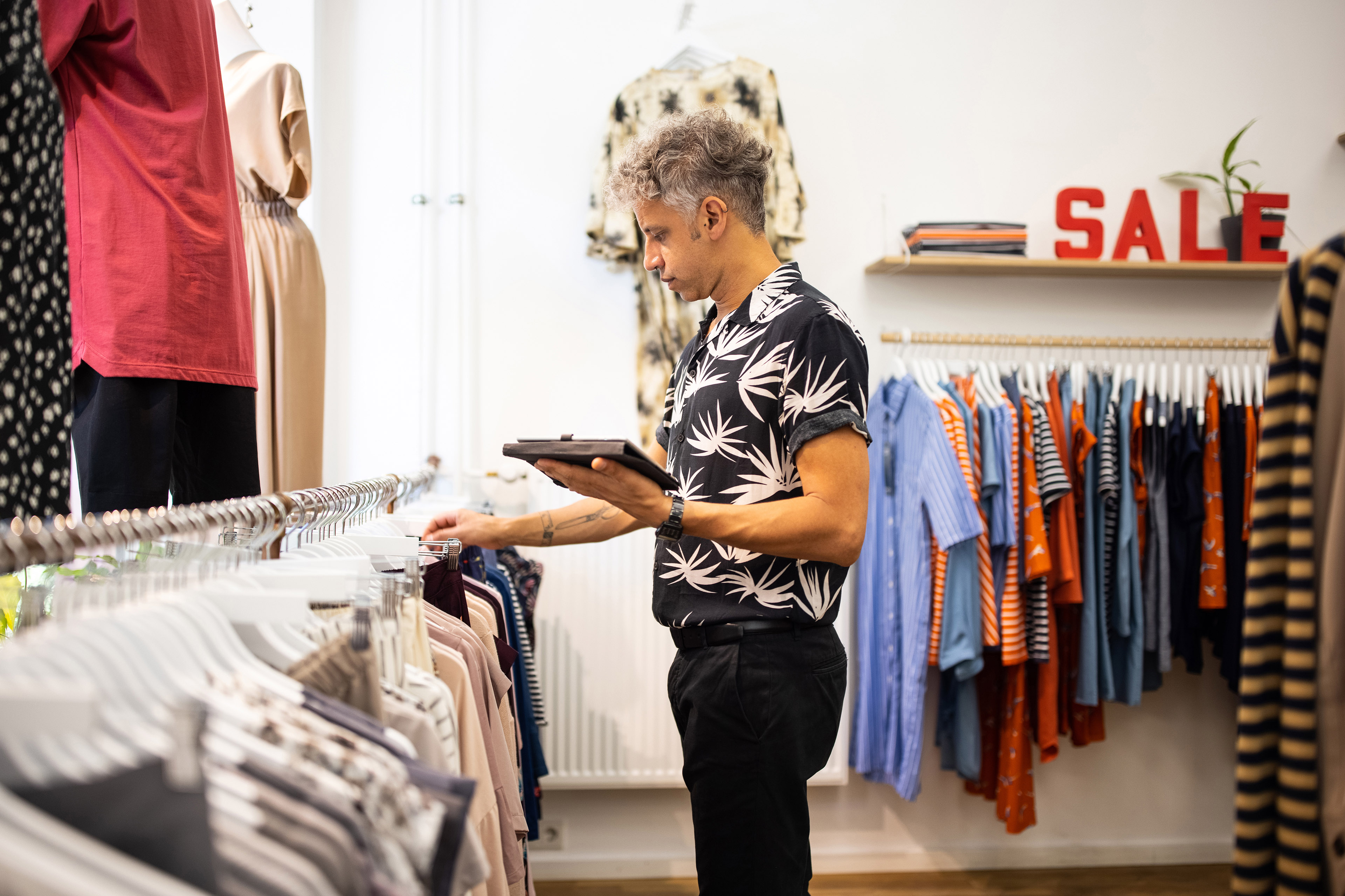 Man choosing clothes from stores