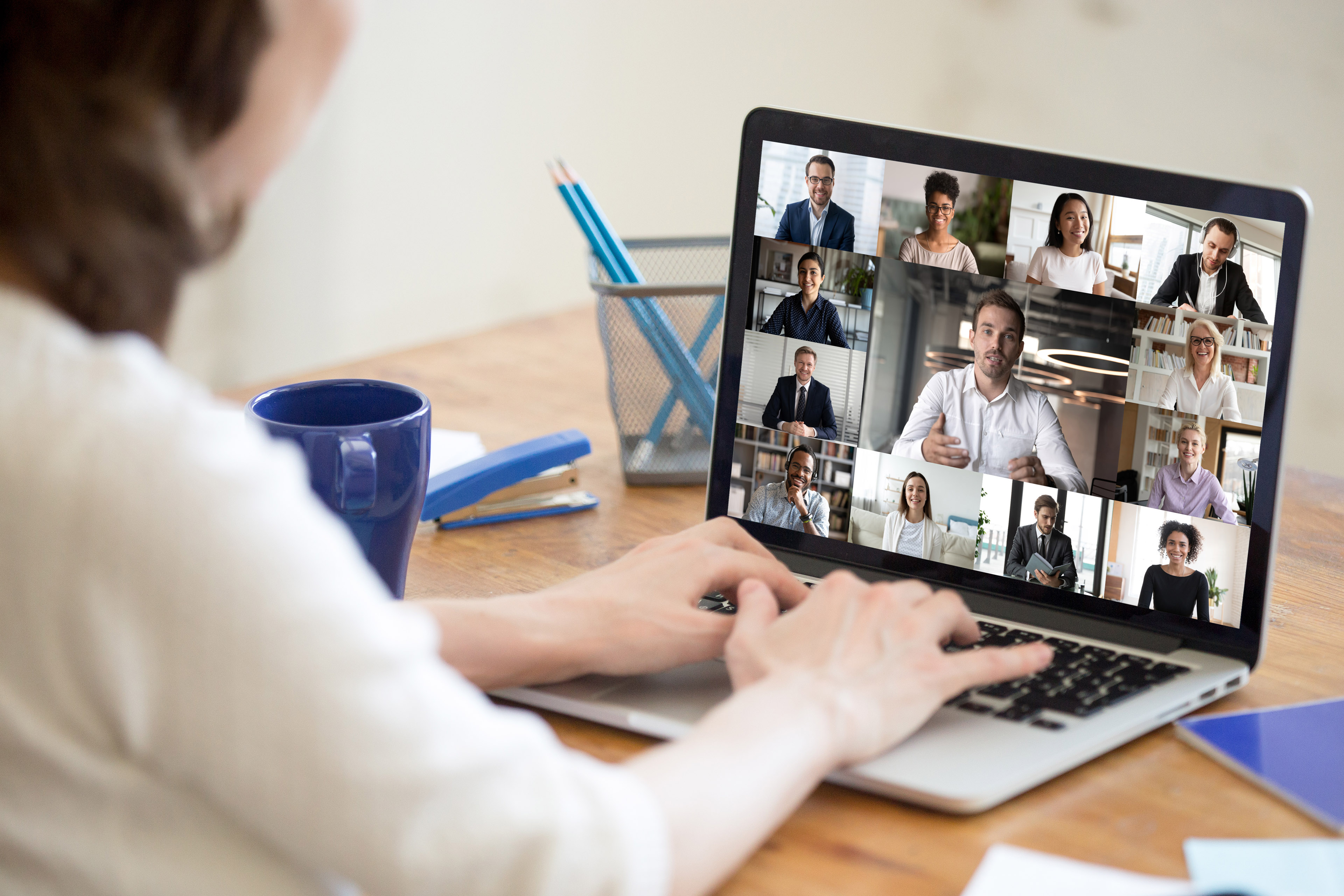 On laptop screen web cam view diverse businesspeople taking part at group videocall