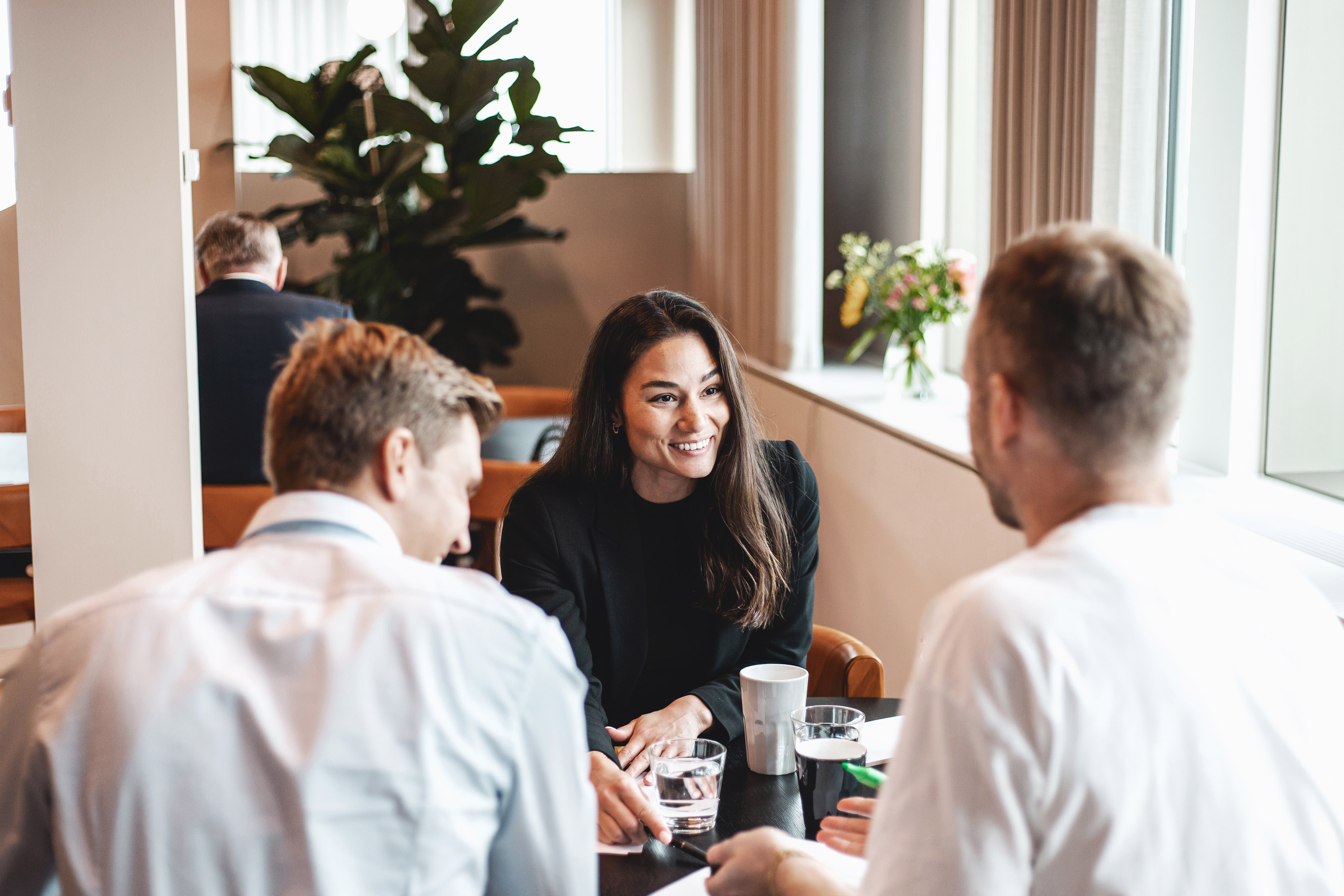 Women talking with friends in cafe