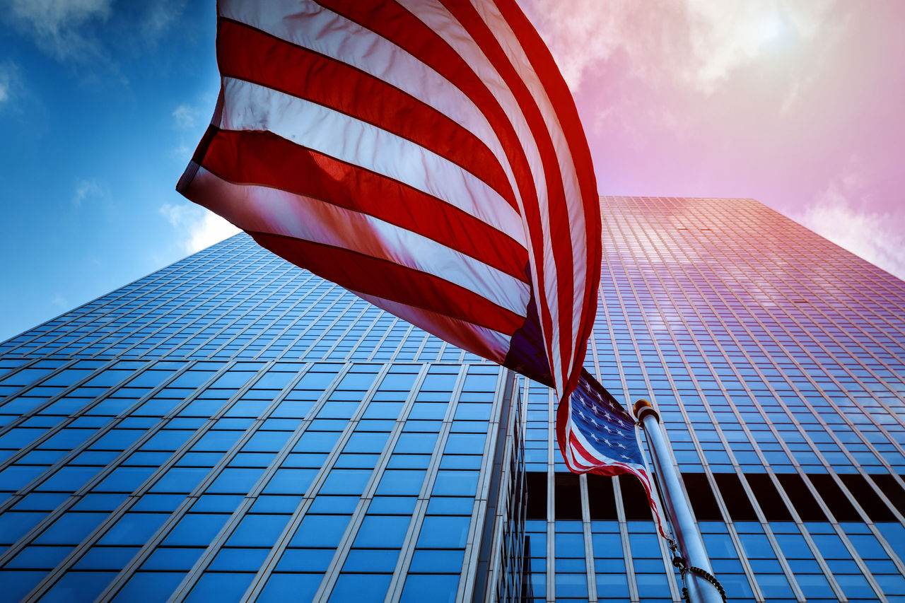View of the Flag of the United States of America Flying in the a High Rise Glass Tower